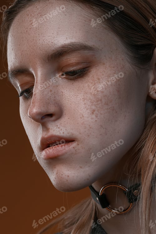 Preview: Portrait Of A Beautiful Girl With Freckles In Studio On A Brown Background