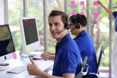 Preview: Businessman typing on keyboard at call center