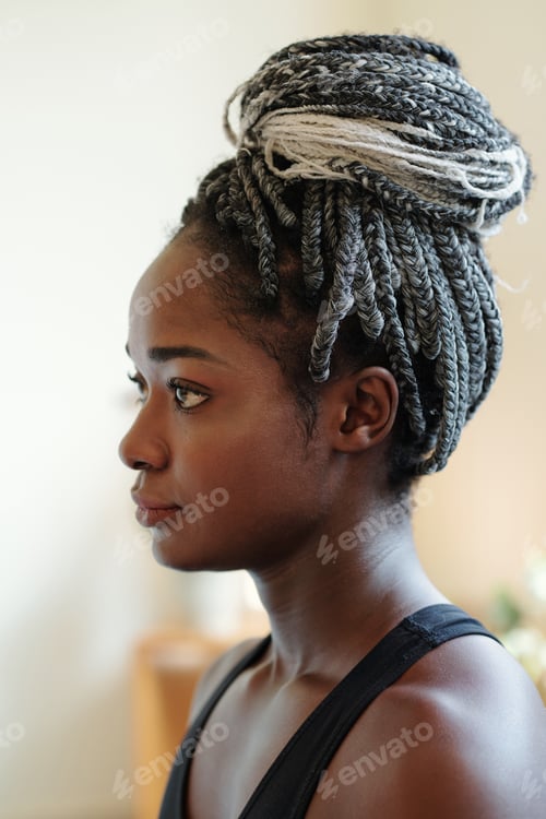 Preview: Woman with Braids Posing in Profile Indoors