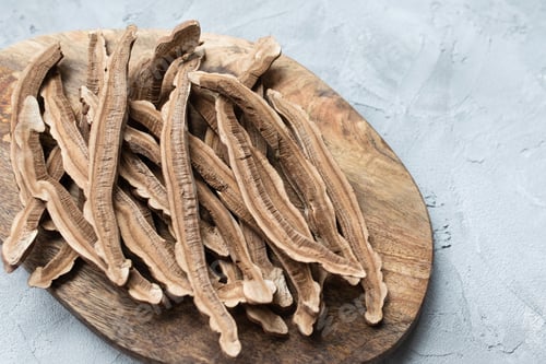 Preview: Slices of dried lingzhi mushroom, also called Reishi, on wooden board