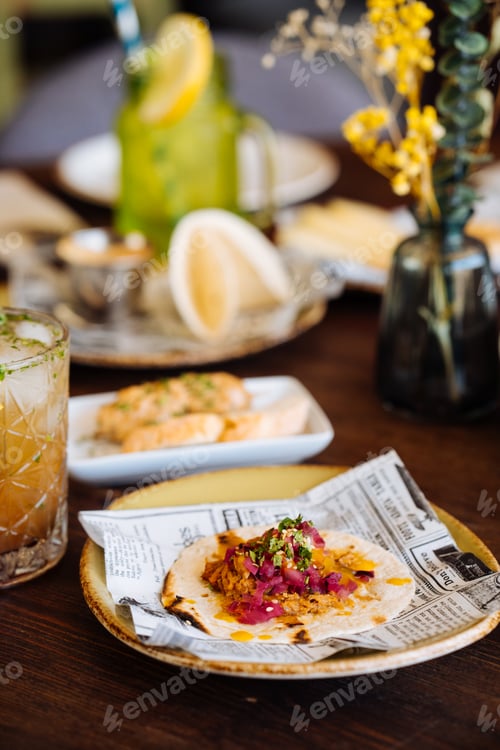 Preview: Delicious taco served on plate with other food in restaurant