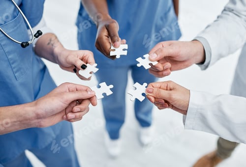 Preview: Closeup shot of a group of medical practitioners holding puzzle pieces