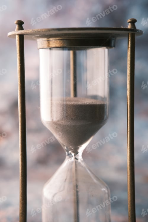Preview: hourglass on table, sand flowing through the bulb of sandglass