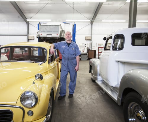 Preview: Portrait of a senior caucasian male owner of an antique car repair shop