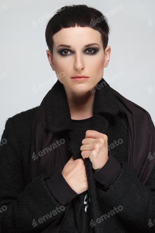 Preview: Pretty young woman with short black hair in black warm coat.
