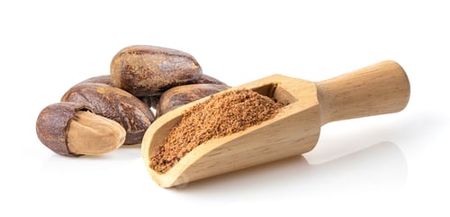 Preview: Nutmeg powder in wood scoop isolated on white background