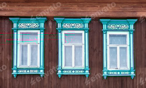 Preview: Ornate Turquoise Window Frames on Wood Building