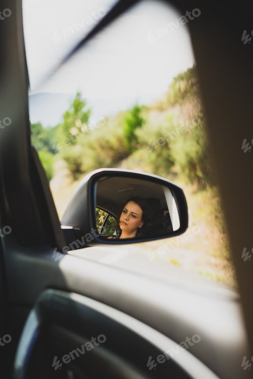 Preview: Portrait of a woman from the mirror of a car