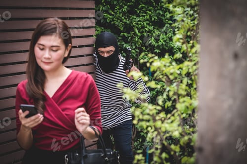 Preview: Thief is holding a gun and looking at asian woman