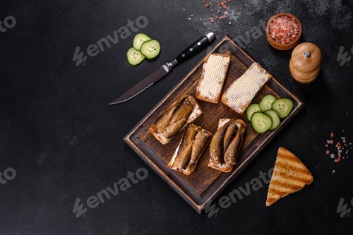 Preview: Delicious fresh sandwich with sprats with crispy toast, butter and cucumber