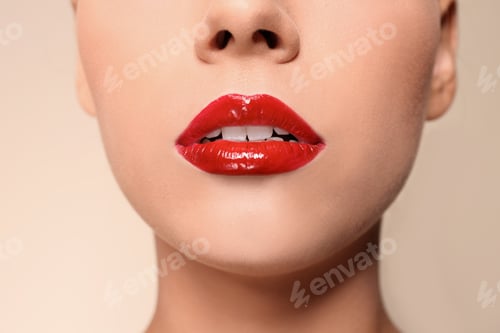 Preview: Beautiful young woman with red glossy lips on color background, closeup