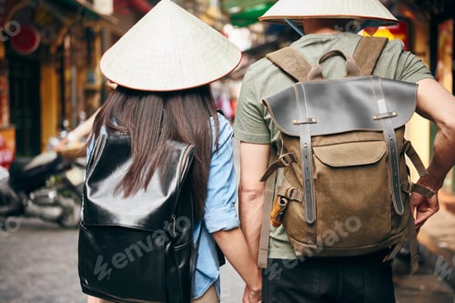 Preview: Back view of tourist with backpack exploring the city