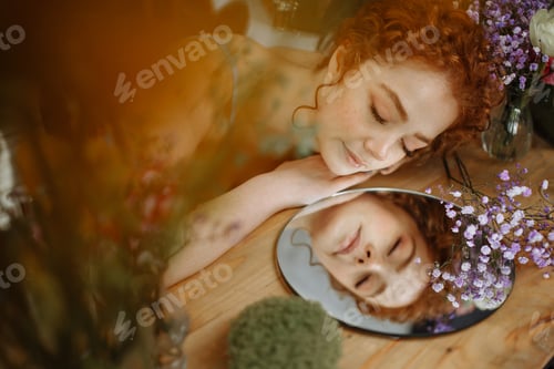 Preview: Beautiful young redhead woman in a greenhouse