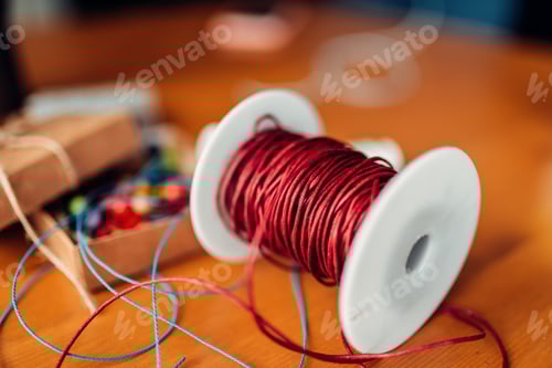 Preview: Needlework, coil with red decorative rope, closeup