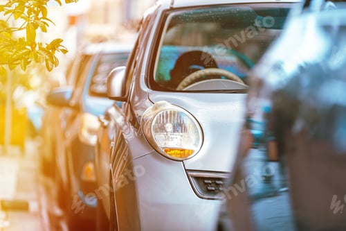 Preview: Many Cars parked in row on street in city in sunny summer day. ecological problem - air pollution