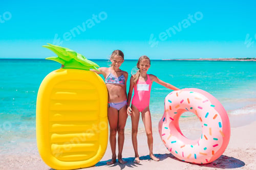 Preview: Little girls having fun at tropical beach during summer vacation playing together