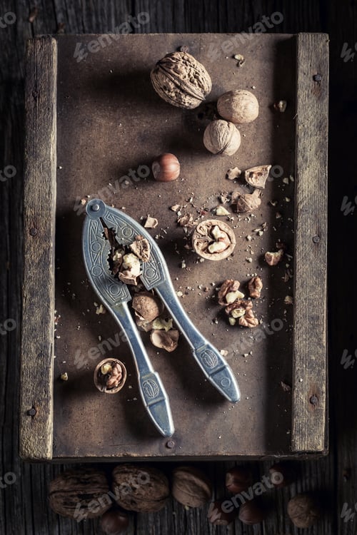 Preview: Healthy walnuts and hazelnuts with on rustic wooden table