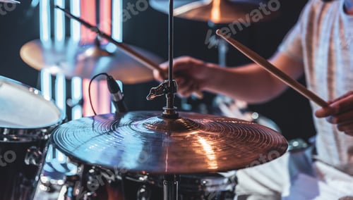 Preview: Close-up of a drummer playing a drum cymbal on a blurred background.