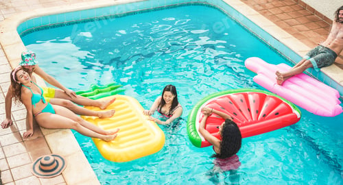 Preview: Young friends floating with air lilos inside swimming pool