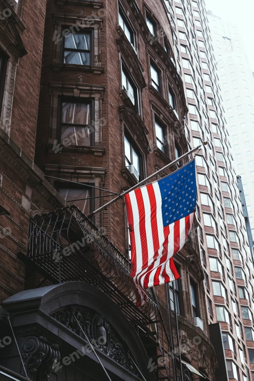 Preview: urban scene with national american flag on street, new york, usa