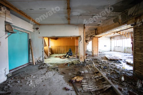 Preview: Dramatic portrait of a woman wearing a gas mask in a ruined building.