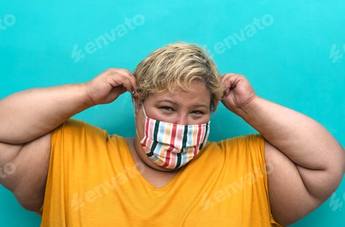 Preview: Happy plus size woman wearing face mask portrait