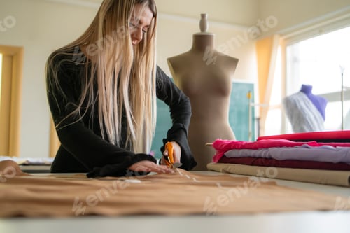Preview: Seamstress focuses on cutting fabric with scissors