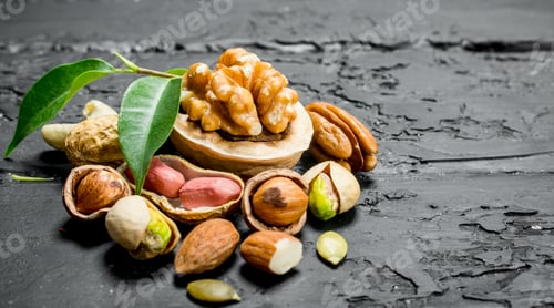 Preview: Nuts background. Different kinds of nuts with leaves.