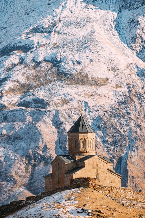 Preview: Stepantsminda, Georgia. Famous Popular Landmark Gergeti Trinity Tsminda Sameba Church In Early
