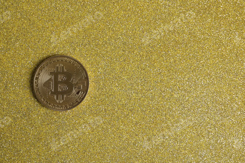 Preview: Bitcoin on golden glittery surface, top view. space for text