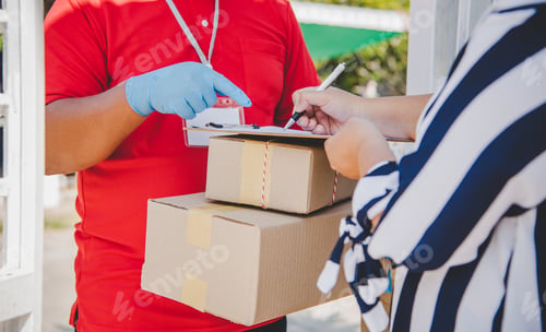 Preview: consumer is signing a document to receive a parcel from a home courier.