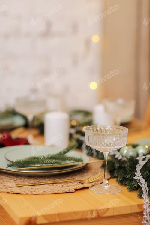 Preview: Festive Christmas and New Year table setting. Dining place decorated with fir branches, garland