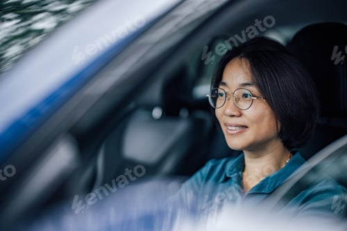 Preview: Mature businesswoman traveling to work by car.