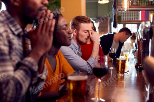 Preview: Group Of Disappointed Customers In Sports Bar Watching Sporting Event On Television