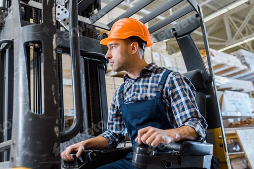 Preview: warehouse worker in uniform and helmet operating forklift machine