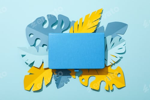 Preview: Yellow and blue tropical leaves in pastel shades on a blue background