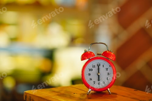 Preview: an alarm clock at 6:00 am on a blurry background