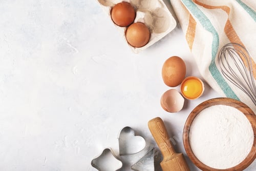 Preview: Ingredients for baking - flour, wooden spoon, eggs.