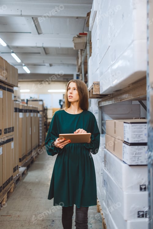 Preview: The young female owner and the man in the warehouse check the temperature, energy consumption and li