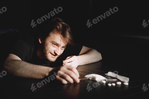 Preview: Junkie man reaches for syringe with dose