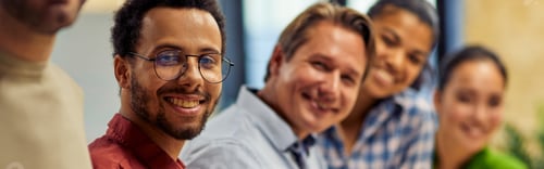 Preview: Successful team. Group of young happy multi ethnic business team looking at camera and smiling