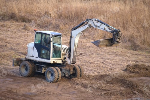 Preview: Earth moving tractor preparing place for future house foundation construction. Leveling soil for