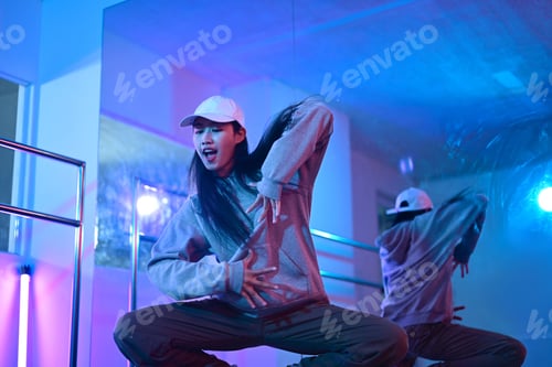 Preview: Shot of young woman practicing modern hip hop dance in studio. Hobbies and active lifestyle