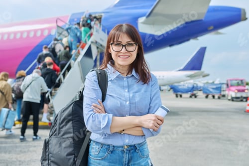 Preview: Middle aged woman with backpack, passengers boarding plane background
