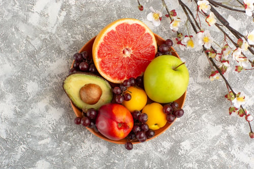 Preview: top view fresh fruits inside plate on white background fruits fresh mellow ripe exotic