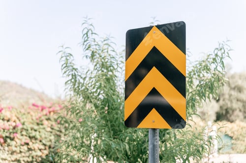 Preview: traffic safety signs on city street road. striped orange black direction movement sign outdoor