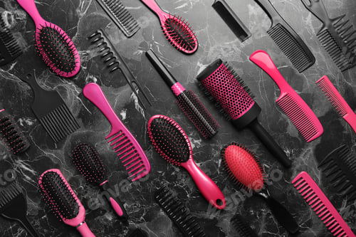 Preview: Flat lay composition with hair brushes and combs on black marble background