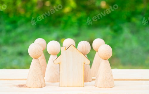 Preview: Family concept. Wooden house and many little men on a wooden table. Property division. Copy space