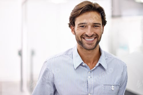 Preview: Hes a confident young businessman. Portrait of a handsome young businessman standing in his office.