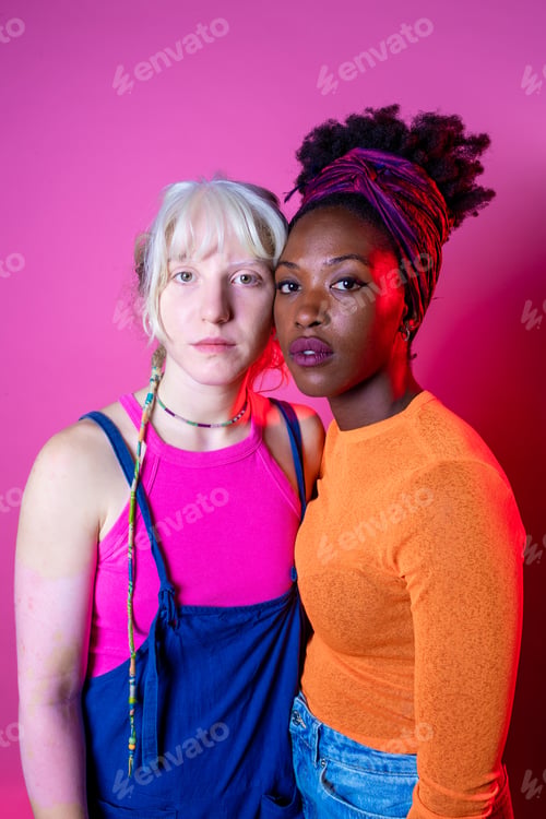 Preview: Two young diverse multicultural caucasian and black women best friends posing isolated background